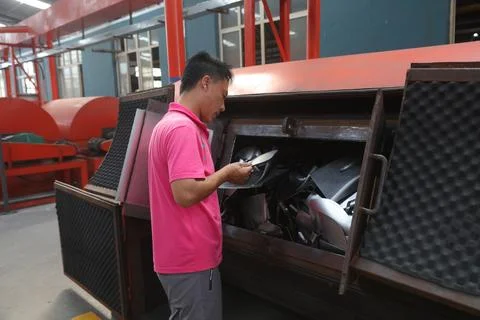 Workers looking at the situation of blade rust removal in a steel shovel ma.. Stock Photos