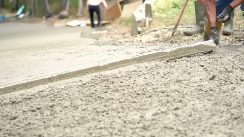 Workers make a concrete path Stock Footage 143899202