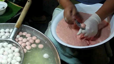 Workers make meatballs from dough with measuring spoons. 4K footage Stock Footage 231503892
