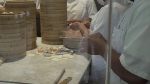 Workers making dumplings by hand. Slow motion.  Video stock 78885783