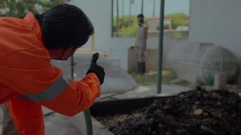 Workers manage organic waste with hydro pump in a circular agribusiness facility Stock Footage 346622945