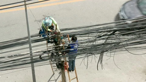 Workers managed and organized messy and unused cord installed on the pole. Stock Footage 220249428