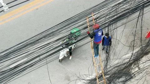 Workers managed and organized messy and unused cord  installed on the pole. Stock Footage 221251028
