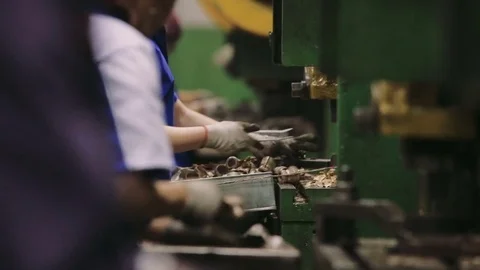 Workers manually assemble components at a Factory. Equipment in the plant. Video stock 73504265