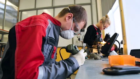Workers in the manufacture of prostheses. Two workers create parts for the Stock Footage 95350607