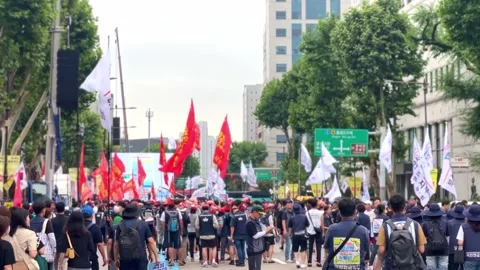 Workers march in protest with flags in Seoul, South Korea, July 15, 2023 Stock Footage 246195497
