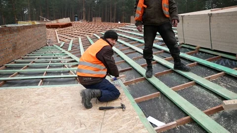 Workers measure the centering of the roof with a thread Stock Footage 326057690