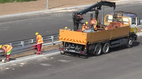 Workers men team mount safety fence on new highway road construction Stock Footage 68758276