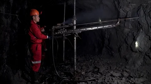 Workers in mine perforating the rock using a pneumatic drill Stock Footage 97161377