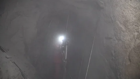 Workers in mine perforating the rock using a pneumatic drill Stock Footage 97162566