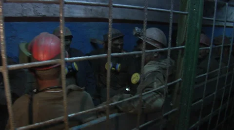 Workers miners Are Sitting Talking Smiling Behind The Grates Men in Workwear in Видео 53504757