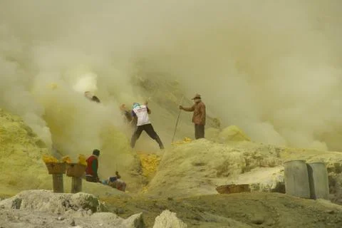 Workers mining sulfur inside volcano Ijen Stock Photos