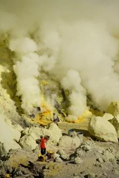 Workers mining sulfur inside volcano Ijen Stock Photos