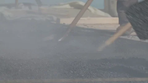 Workers mix hot asphalt while building a road Stock Footage 104194163
