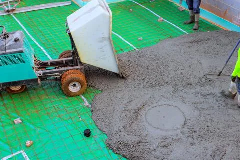 Workers mix pour concrete for construction project on building site Stock Photos