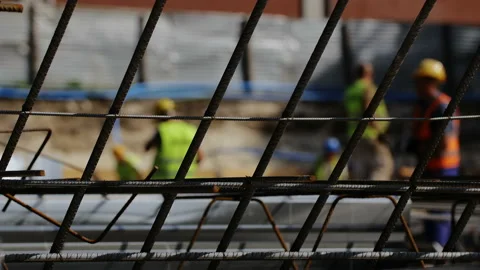 Workers on a modern construction site making steel reinforcement Stock Footage 89916035