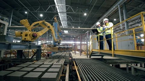 Workers at a modern plant testing new industrial robotic equipment. Stock Footage 114713400