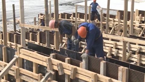 Workers mount the formwork of a reinforced concrete structure Stock Footage 104195170