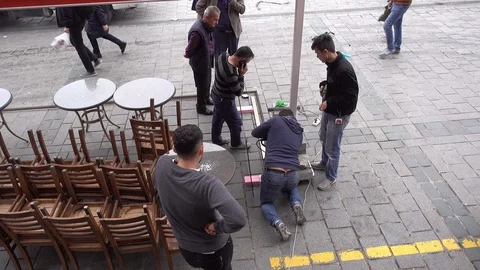 Workers mount the structure. They are building a street cafe. Video stock 87910497