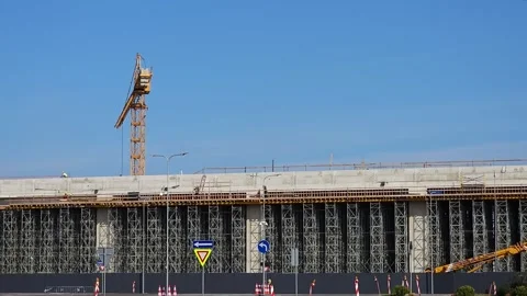 Workers move across construction building carefully navigating structure with Stock Footage 286081129