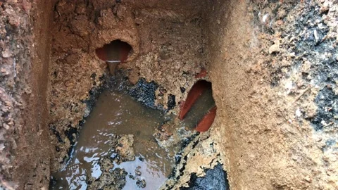Workers move the manhole cover to clean the sewer line for clogs Stock Footage 101182460