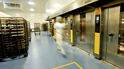 Workers moving and baking pastries at a commercial bakery Video stock 1210864