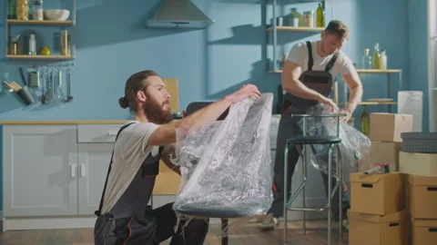 Workers of Moving Company With Uniforms Carefully Unpacking Things at Boxes. Video stock 241396853