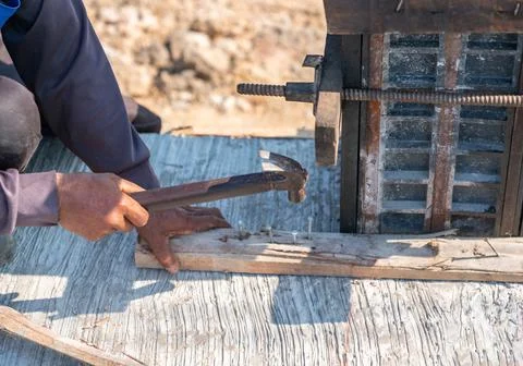 Workers nailed the pole framework slats to pour the concrete. Stock Photos