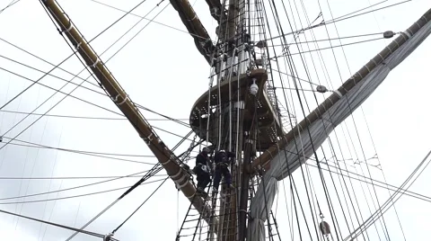 Workers in the navy adjust canvas Stock Footage 63374409