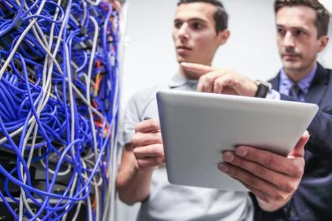 Workers in network server room Stock Photos
