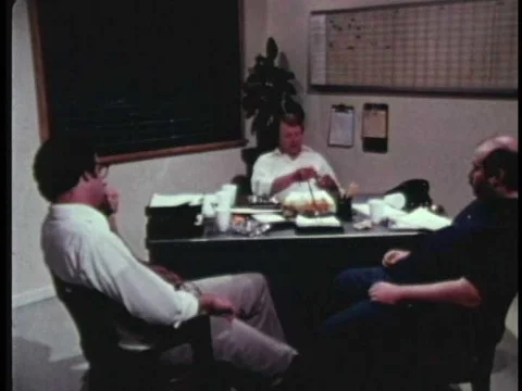 Workers in an office discuss packaging procedures, a boy at summer camp gets aƒ Stock Footage 75277118