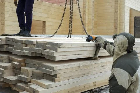 Workers offloading timber 写真素材