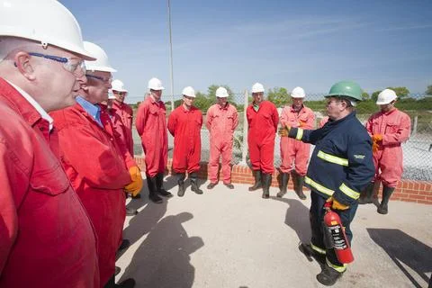 Workers in the offshore industry practice fire fighting as part of an industr Stock Photos