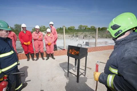 Workers in the offshore industry practice fire fighting as part of an industr Stock Photos