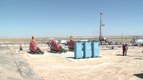 Workers at an oil field in the desert confer. Stock Footage 149263143