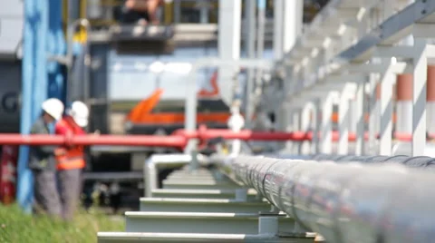 Workers at the oil refinery put pipes Stock Footage