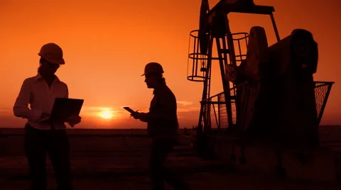 Workers in an Oilfield at Sunset Stock Footage 47464460