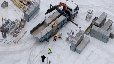 Workers open a truck crane to upload a concrete block at the construction site Video stock 236474669