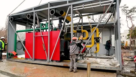 Workers operate a crane, lower it to the ground and install the building of a Video stock 285774231