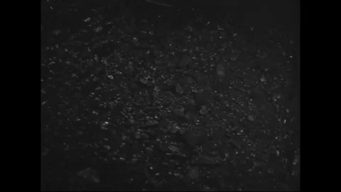 Workers operate machinery to sort the raw material of coal - 1942-1945 Stock Footage 99782680