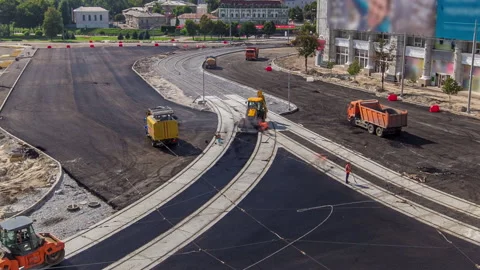 Workers operating asphalt paver machines during road construction and repairing Stock Footage 190529800