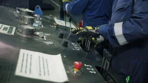 Workers operating drill testing control panel at oil facility Stock Footage 309324176