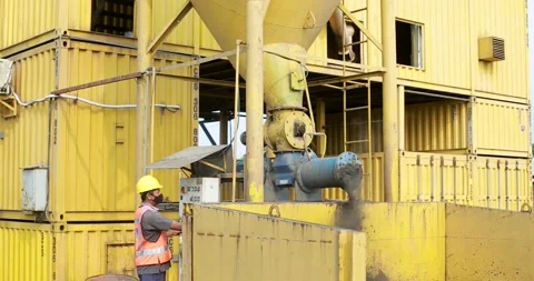 Workers operating machinery in asphalt mixing plant Stock Footage 170406627