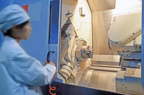 Workers in the operation of cnc machine tools Stock Photos