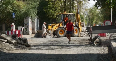 Workers in Orange Workwear Driver Inside of Yellow Excavator Cabin Safety Red Stock Footage 54330421