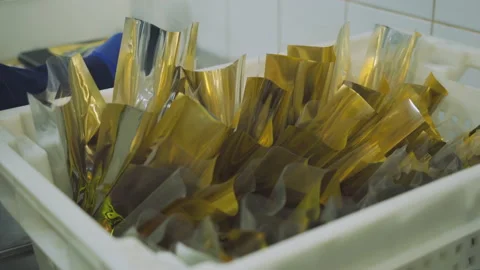 Workers pack and weigh meat snacks at a meat factory. Meat food, meat factory 库存影片 131857437