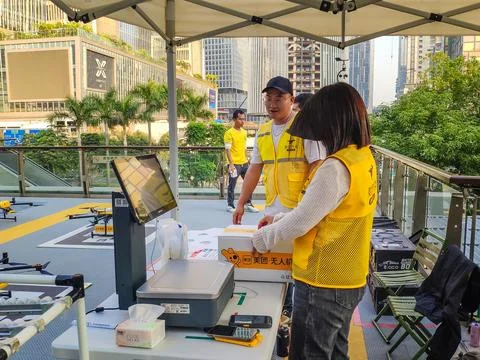 Workers pack food for delivery drones Stock Photos