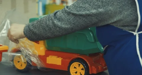 Workers pack a plastic part for the production of toys Stock Footage 120124206