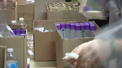 Workers packaging aid and supplies for homeless people living on the streets Stock Footage 46002873