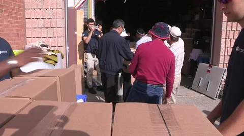 Workers packaging aid supplies for refugees from war in Syria and middle east Stock Footage 55348769